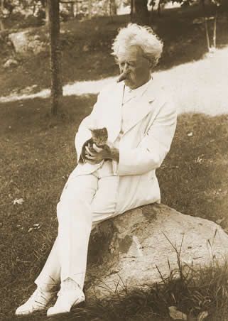 Mark Twain holding cat in his lap